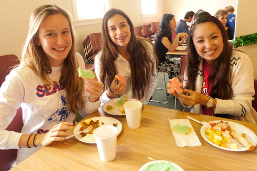 Sophomores Amy Ozee, Bel Cagen, and Katelyn McCollor get into the holiday spirit by decorating cookies during lunch on Friday, Dec. 13.