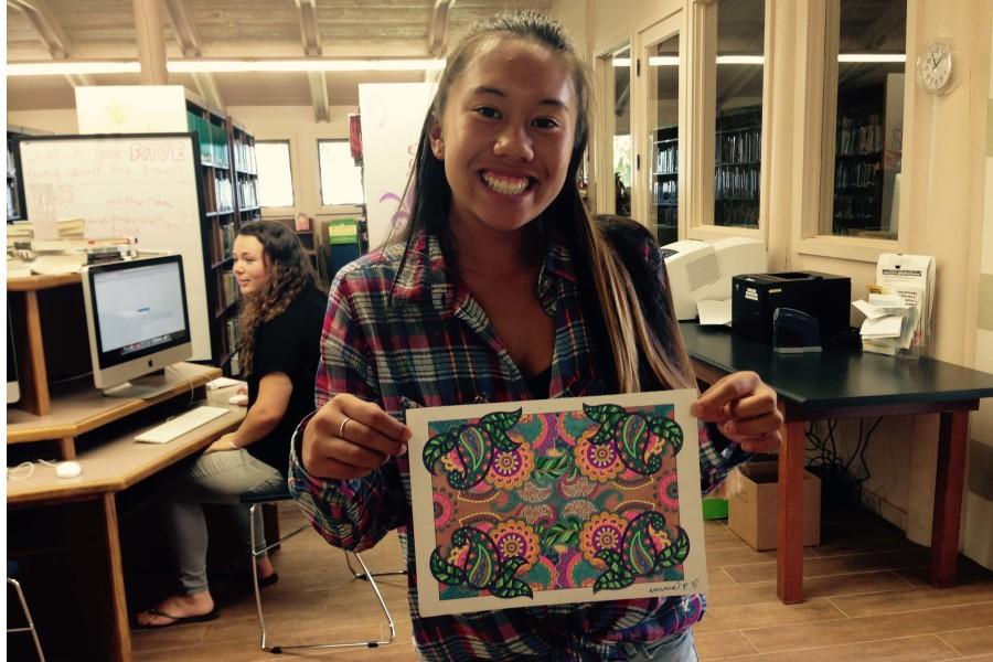 Senior Emma Pilotin shows off a page she colored during Seabury Hall's Castle Library's Library Unplugged program.