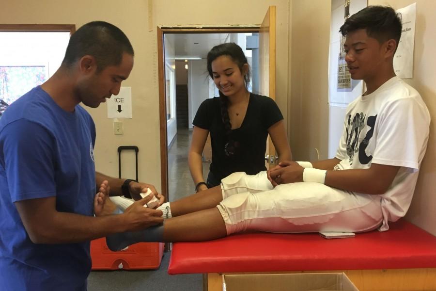 Kevin Yamashiro, Seabury Hall's new athletic trainer, helps care for the school's student athletes.