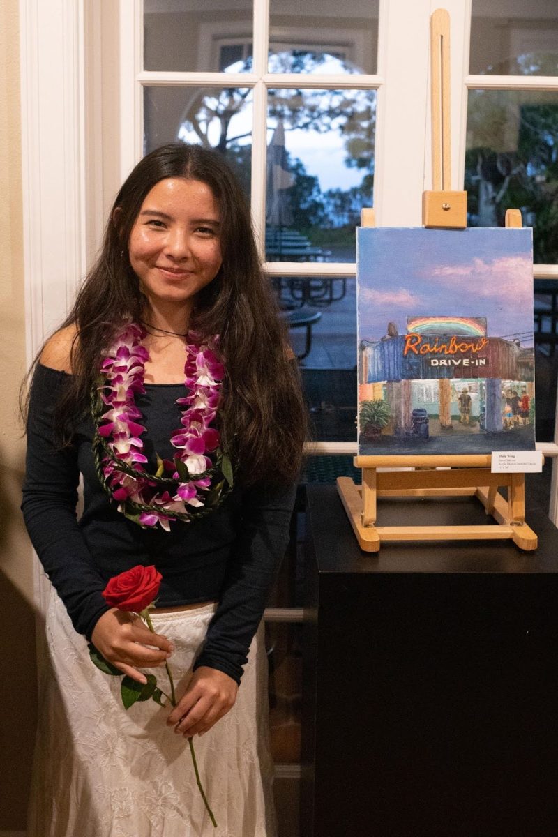 Seabury Hall senior Maile Wong stands by her painting Sunset Take-Out during the AP Art show. 
