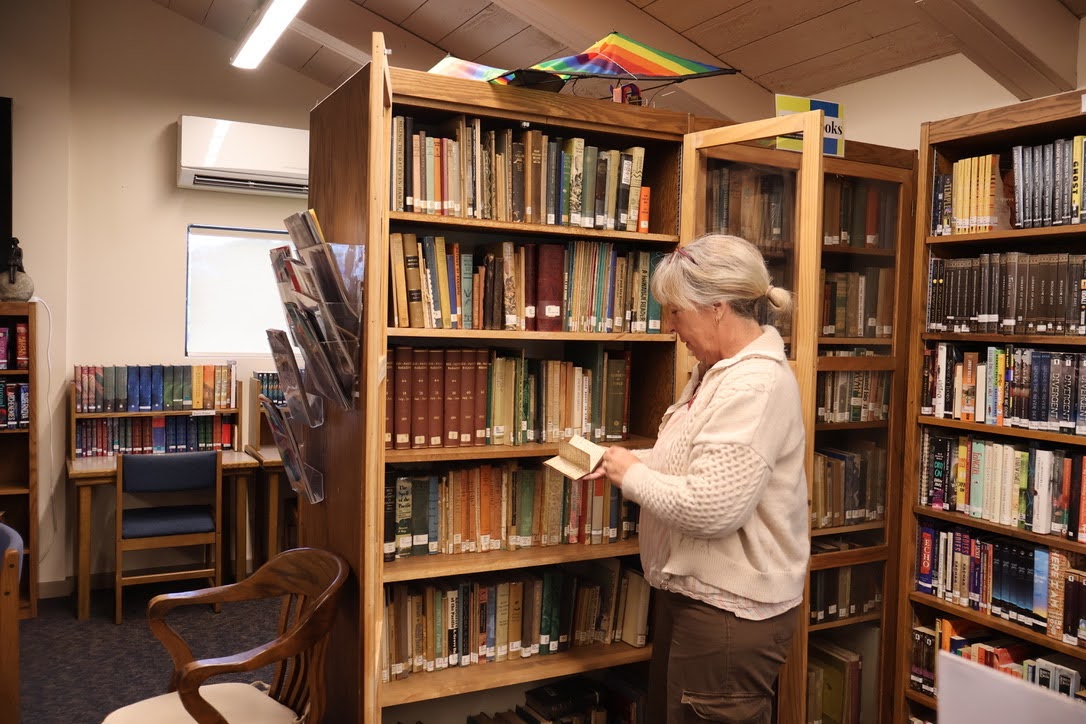 Librarian Ms. Quiocho showcases first edition novels at the Castle Library at Seabury Hall on Friday morning.