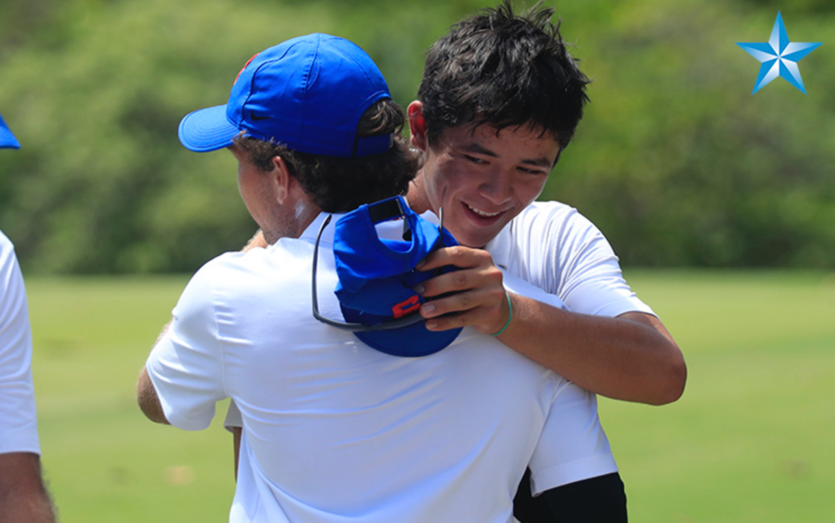 Tyler Loree, right, embraces team mate Daniel Arashiro-Garcia on the 18th green after the final round of the 2024 HHSAA Boys Golf championship.